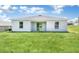 View of the back of the house showing access to the yard via a sliding glass door at 14322 Sw 28Th Ave, Ocala, FL 34473