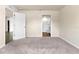 Bright and airy bedroom with neutral carpet and walls, along with an open door to an en-suite bathroom at 14322 Sw 28Th Ave, Ocala, FL 34473