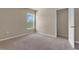 Empty bedroom featuring plush carpeting and natural light from the window at 14322 Sw 28Th Ave, Ocala, FL 34473