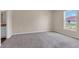 Spacious bedroom with neutral carpet, walls, and a window, offering a calming and inviting retreat at 14322 Sw 28Th Ave, Ocala, FL 34473