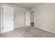 Empty bedroom with plush carpeting and two doors to other rooms at 14322 Sw 28Th Ave, Ocala, FL 34473