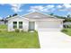 Charming single-story home featuring a two-car garage, well-manicured lawn, and a clean, modern facade at 14322 Sw 28Th Ave, Ocala, FL 34473