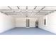 Spacious garage featuring freshly painted walls and floor with a water heater in the corner at 14322 Sw 28Th Ave, Ocala, FL 34473
