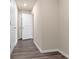 Hallway with clean neutral walls, white doors, and handsome, easy-care wood-look flooring at 14322 Sw 28Th Ave, Ocala, FL 34473