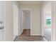 Hallway with views to a bathroom and bedroom, with wood-look floors at 14322 Sw 28Th Ave, Ocala, FL 34473