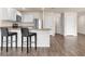Kitchen with white cabinets, stainless steel appliances, granite countertops, and convenient bar stool seating at 14322 Sw 28Th Ave, Ocala, FL 34473