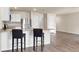 Kitchen with granite countertops, stainless steel refrigerator, and bar stool seating providing style and functionality at 14322 Sw 28Th Ave, Ocala, FL 34473