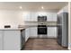 Kitchen area with stainless appliances, granite countertops, and white cabinetry at 14322 Sw 28Th Ave, Ocala, FL 34473