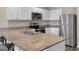 Modern kitchen featuring granite counters, stainless steel appliances, ample cabinet space, and a convenient sink area at 14322 Sw 28Th Ave, Ocala, FL 34473