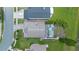 Aerial view of the home showcases a screened pool and backyard by a lake at 14566 Quail Trail Cir, Orlando, FL 32837