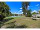 Expansive backyard with a charming lake view and a relaxing swing set at 14566 Quail Trail Cir, Orlando, FL 32837