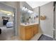 Bathroom featuring a double vanity, and view into an adjacent bedroom at 14566 Quail Trail Cir, Orlando, FL 32837