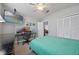 Bright bedroom features a ceiling fan, multiple monitors and a doorway leading into the rest of the house at 14566 Quail Trail Cir, Orlando, FL 32837
