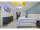 Bedroom with modern decor, a queen sized bed, wood floor, and a blue accent wall at 14566 Quail Trail Cir, Orlando, FL 32837