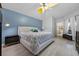 Bedroom with modern decor, a queen sized bed, wood floor, and a blue accent wall at 14566 Quail Trail Cir, Orlando, FL 32837