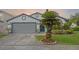 Charming single-Gathering home featuring a well-maintained lawn and a two-car garage at 14566 Quail Trail Cir, Orlando, FL 32837