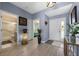 Welcoming foyer with a view of the bathroom, bedrooms, and an elegant light fixture at 14566 Quail Trail Cir, Orlando, FL 32837