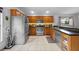 Spacious kitchen features stainless steel appliances, oak cabinets, a breakfast bar, and durable tile flooring at 14566 Quail Trail Cir, Orlando, FL 32837
