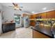 Bright kitchen with stainless appliances, oak cabinets, breakfast bar, and large window with a scenic view at 14566 Quail Trail Cir, Orlando, FL 32837