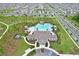 A drone's perspective of a neighborhood showcasing the pool, community center and manicured landscaping at 1565 Diamond Loop Dr, Kissimmee, FL 34744