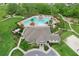 Aerial shot of community pool, clubhouse, and recreational areas with ample seating and manicured landscaping at 1565 Diamond Loop Dr, Kissimmee, FL 34744