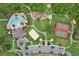 Overhead view of amenity center: pool, tennis, playground, volleyball, green space, and covered seating at 1565 Diamond Loop Dr, Kissimmee, FL 34744