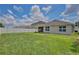 A spacious backyard with lush green grass, enclosed by a white fence for privacy at 1565 Diamond Loop Dr, Kissimmee, FL 34744
