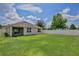 A spacious backyard with lush green grass, enclosed by a white fence for privacy at 1565 Diamond Loop Dr, Kissimmee, FL 34744