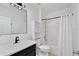 Bathroom featuring a single vanity, a mirror, and a shower over tub with a white shower curtain at 1565 Diamond Loop Dr, Kissimmee, FL 34744