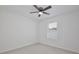 Bright bedroom with wood look flooring, a ceiling fan, and a bright window that offers nice outdoor views at 1565 Diamond Loop Dr, Kissimmee, FL 34744