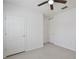 Bedroom featuring light flooring, a ceiling fan, and multiple white doors, offering a blank canvas for personalization at 1565 Diamond Loop Dr, Kissimmee, FL 34744