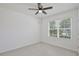 Bright bedroom with a ceiling fan, a large window, and neutral walls, offering a comfortable and inviting space at 1565 Diamond Loop Dr, Kissimmee, FL 34744