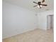Spacious bedroom features tile flooring, a ceiling fan, and neutral paint, providing a bright and airy atmosphere at 1565 Diamond Loop Dr, Kissimmee, FL 34744