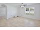 Bright bedroom with tile flooring, ceiling fan, neutral walls, and a large window for natural light at 1565 Diamond Loop Dr, Kissimmee, FL 34744