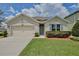 Charming single-story home features a well-kept lawn, tasteful landscaping, and an attached two-car garage at 1565 Diamond Loop Dr, Kissimmee, FL 34744