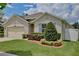 Charming house features a manicured front lawn and an attached two-car garage in a suburban neighborhood at 1565 Diamond Loop Dr, Kissimmee, FL 34744