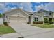 Charming single-Gathering home with a two-car garage, well-manicured lawn, and beautiful landscaping at 1565 Diamond Loop Dr, Kissimmee, FL 34744