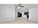 Bright living room with tile floors open to the modern kitchen with dark cabinets and a white quartz island at 1565 Diamond Loop Dr, Kissimmee, FL 34744