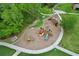 Aerial shot of a well-maintained community playground with various play structures and ample green space at 1565 Diamond Loop Dr, Kissimmee, FL 34744