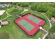 Aerial image featuring community tennis courts surrounded by lush greenery and walking paths at 1565 Diamond Loop Dr, Kissimmee, FL 34744