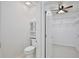 A water closet with open doorway to a walk-in closet and built-in shelving at 1565 Diamond Loop Dr, Kissimmee, FL 34744