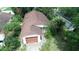 Overhead view of a single-Gathering home showing the roof, attached garage, mature trees and landscaping at 1612 Eastern Ave, St Cloud, FL 34771