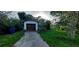 View of a home's front, showcasing a driveway, yard and single-car garage at 1612 Eastern Ave, St Cloud, FL 34771