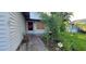 A front entrance and porch with mature trees and foliage at 1612 Eastern Ave, St Cloud, FL 34771