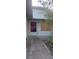 A front entrance and porch with a walkway and mature trees at 1612 Eastern Ave, St Cloud, FL 34771