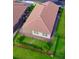 Aerial view of home with well-maintained backyard and brick-paved patio at 1709 Benoit Ter, Davenport, FL 33837