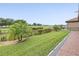 Scenic backyard view featuring lush green grass and a well-manicured landscape bordering a golf course at 1709 Benoit Ter, Davenport, FL 33837
