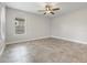 Spacious bedroom with tile flooring, ceiling fan, and large windows at 1709 Benoit Ter, Davenport, FL 33837