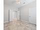 Neutral bedroom showcases tile floors, a ceiling fan, and entry to another bedroom or closet at 1709 Benoit Ter, Davenport, FL 33837