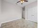 Bedroom features tile floors, ceiling fan, closet and entrance to another bedroom or closet at 1709 Benoit Ter, Davenport, FL 33837